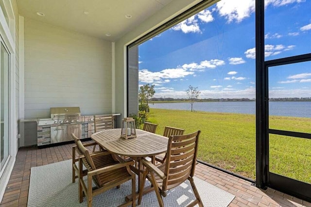 sunroom / solarium with a water view