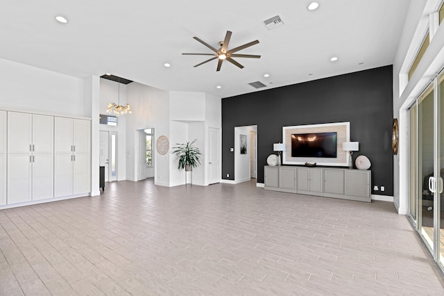 living room with light hardwood / wood-style flooring and ceiling fan with notable chandelier