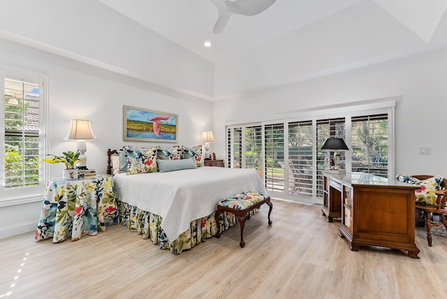 bedroom with access to exterior, light hardwood / wood-style flooring, multiple windows, and ceiling fan