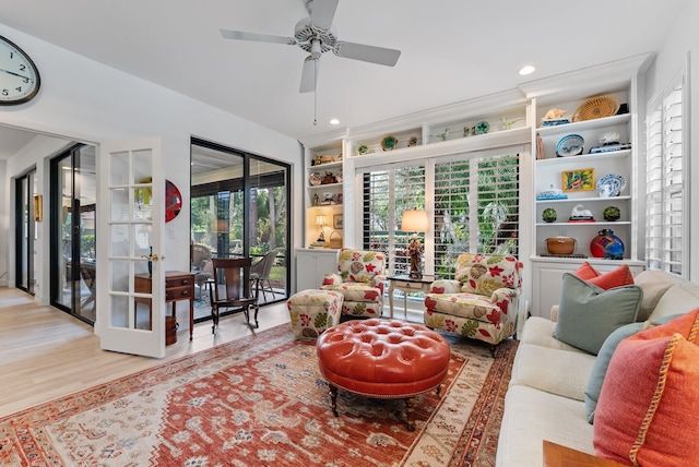 sunroom / solarium with ceiling fan and french doors