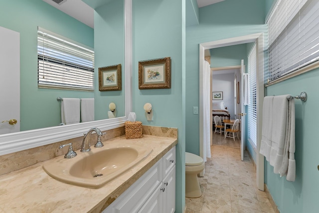 bathroom featuring tile patterned flooring, vanity, and toilet