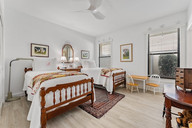 bedroom with ceiling fan and light hardwood / wood-style flooring