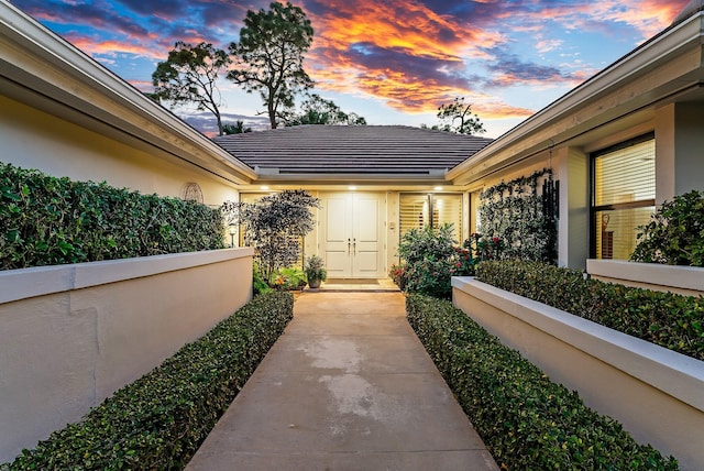 view of exterior entry at dusk