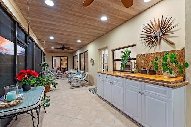 interior space with wooden ceiling and light tile patterned flooring