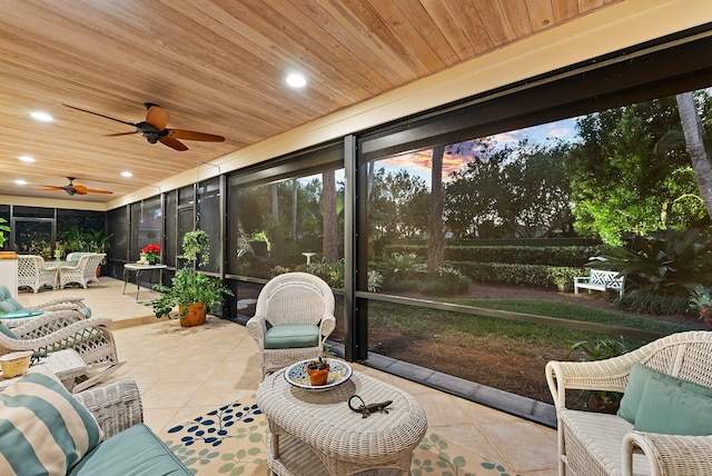 sunroom with ceiling fan and wooden ceiling