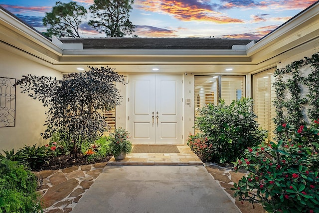 view of exterior entry at dusk