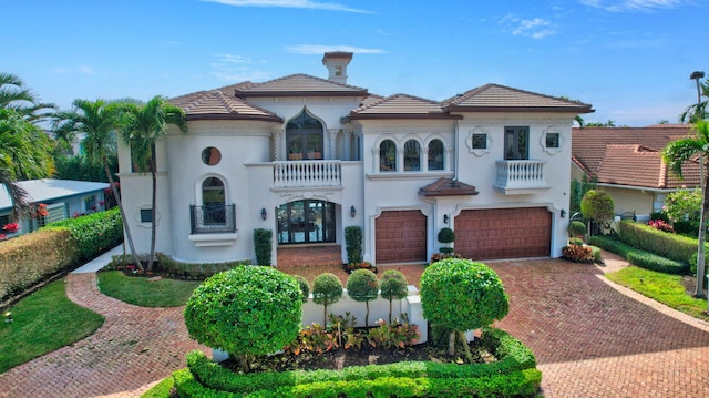 mediterranean / spanish house with a balcony and a garage