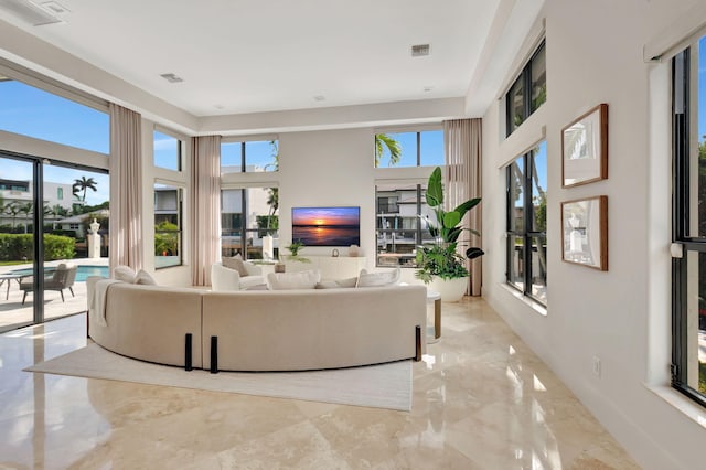 living room featuring a towering ceiling