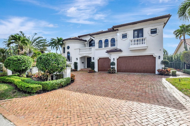 mediterranean / spanish-style home featuring a balcony and a garage