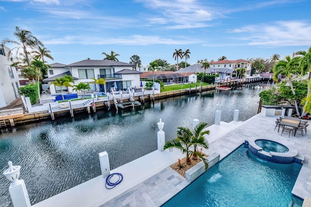 exterior space with a patio area, a water view, and an in ground hot tub