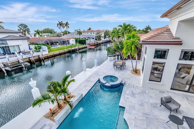 view of swimming pool with an in ground hot tub, a patio, and a water view