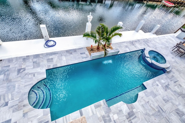 view of swimming pool with an in ground hot tub