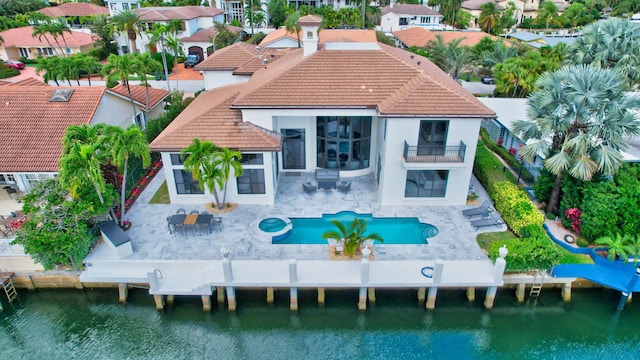 rear view of property with a patio area and a water view