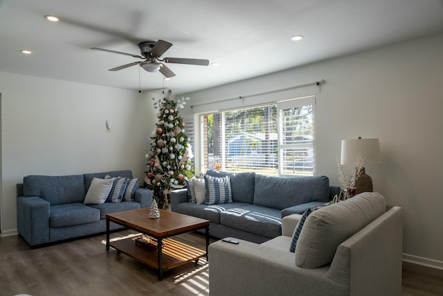 living room featuring dark hardwood / wood-style floors and ceiling fan