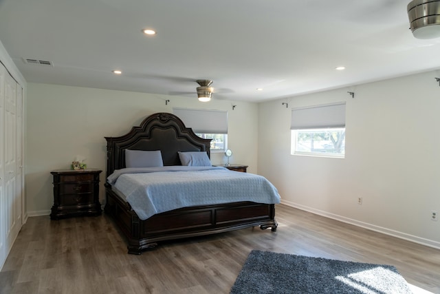 bedroom with hardwood / wood-style flooring, ceiling fan, and a closet