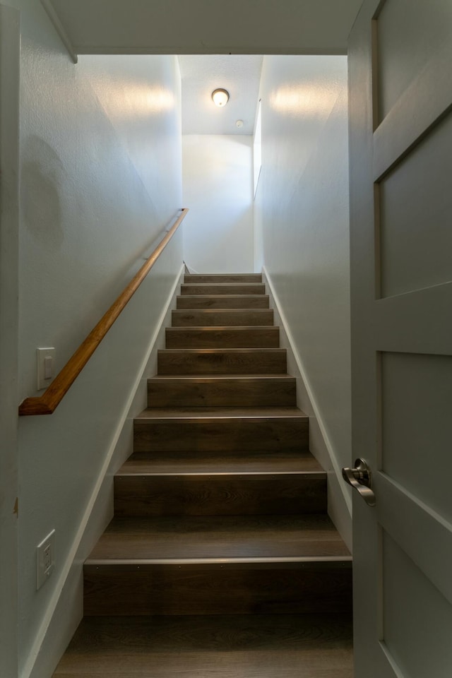 stairs featuring wood-type flooring