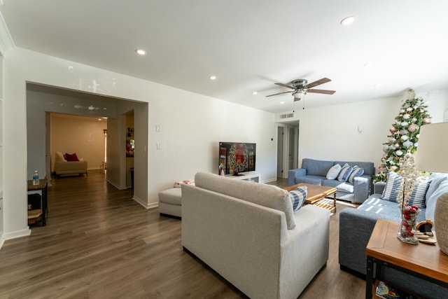 living room with ceiling fan and dark hardwood / wood-style flooring