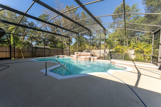 view of pool with a lanai and a patio