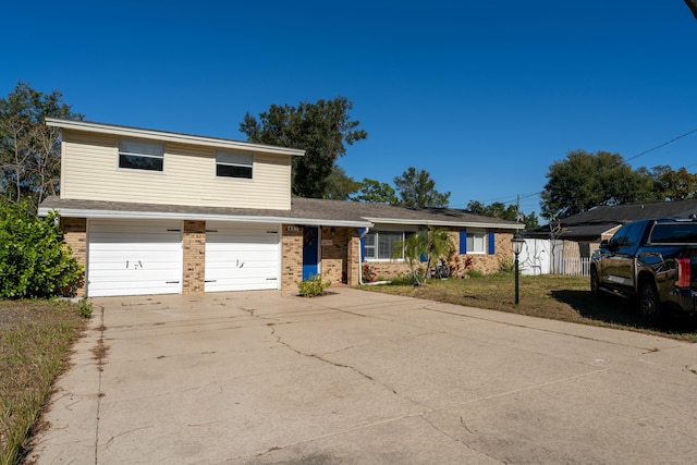 view of front facade with a garage and a front lawn