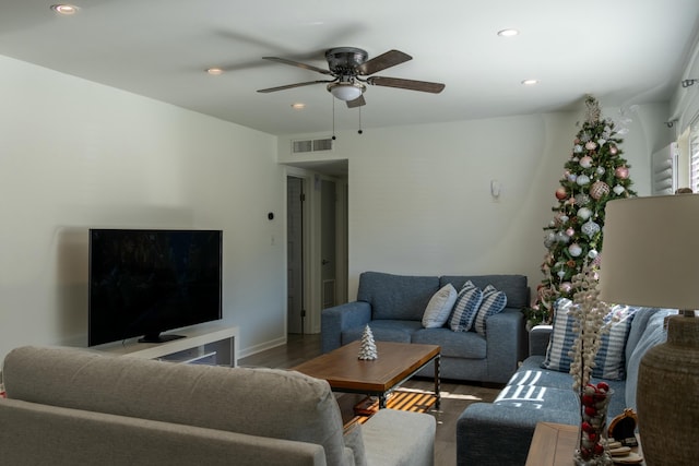 living room featuring wood-type flooring and ceiling fan