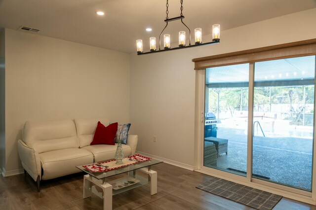 living room featuring a notable chandelier and hardwood / wood-style flooring