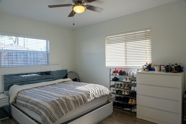 bedroom featuring ceiling fan and dark wood-type flooring