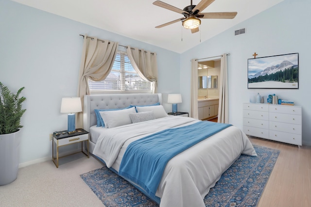 bedroom with ceiling fan, wood-type flooring, lofted ceiling, and ensuite bathroom