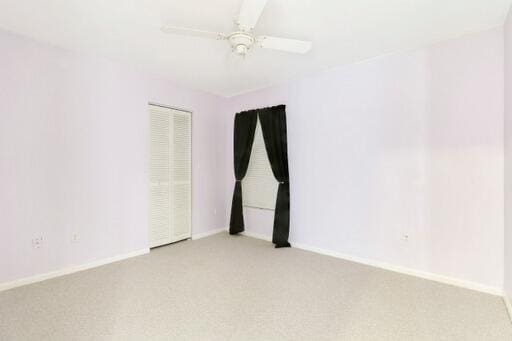 unfurnished room featuring ceiling fan and light colored carpet