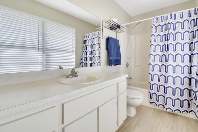 full bathroom with hardwood / wood-style floors, vanity, toilet, and shower / tub combo with curtain