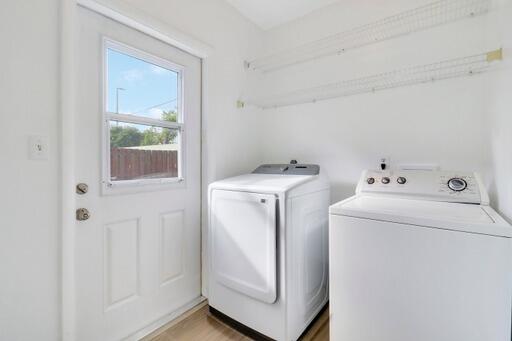 laundry area featuring washer and dryer and wood-type flooring