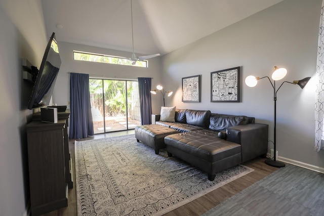 living room featuring high vaulted ceiling and dark wood-type flooring