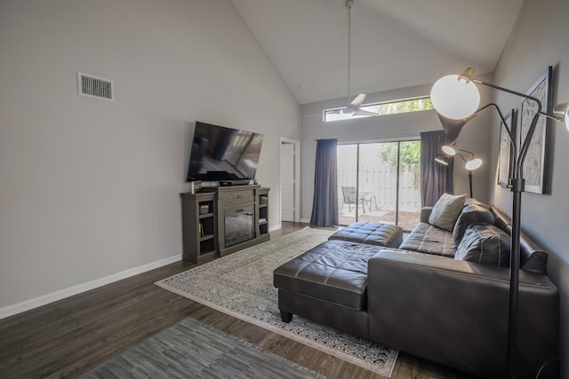 living room with high vaulted ceiling and dark wood-type flooring