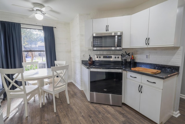 kitchen with backsplash, dark wood-type flooring, ceiling fan, white cabinetry, and stainless steel appliances