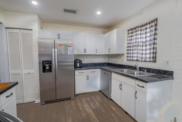 kitchen with white cabinets, sink, dark hardwood / wood-style flooring, and stainless steel appliances