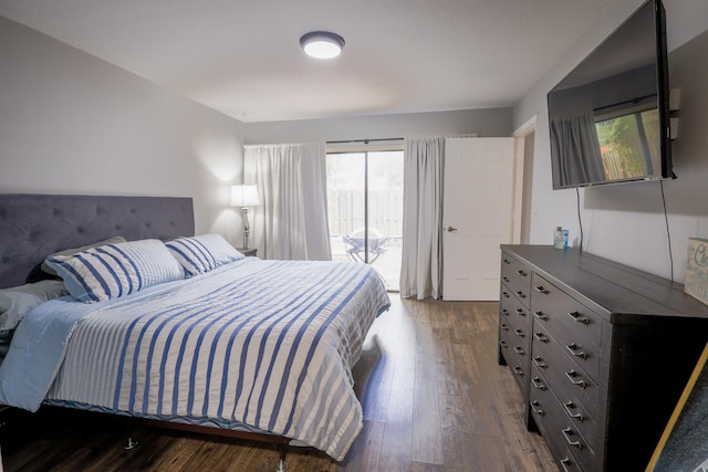 bedroom featuring dark wood-type flooring and access to outside