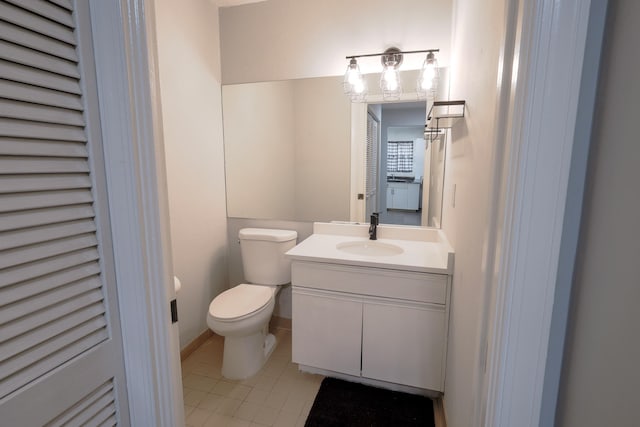 bathroom with tile patterned flooring, vanity, and toilet