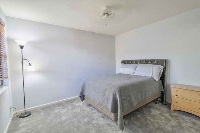 bedroom with ceiling fan and dark carpet