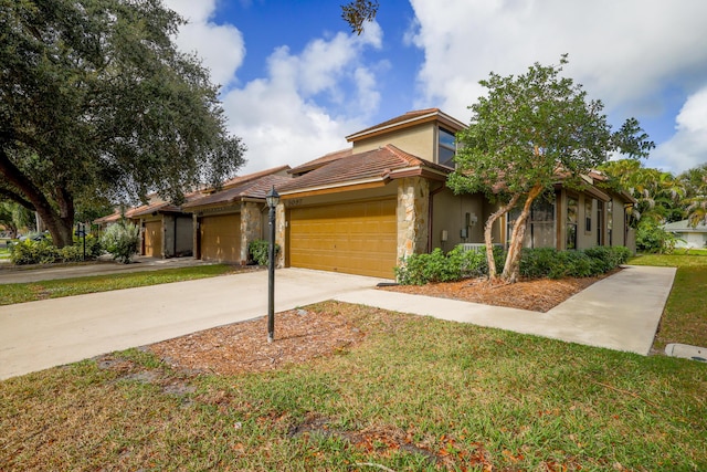 mediterranean / spanish-style house with a garage and a front yard