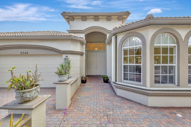 view of exterior entry featuring a garage