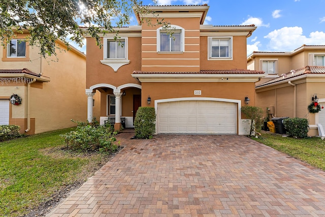 mediterranean / spanish-style home with a garage