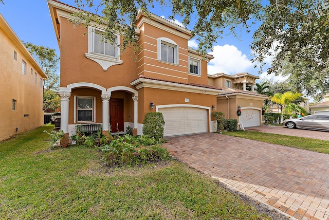 view of front facade featuring a front lawn and a garage