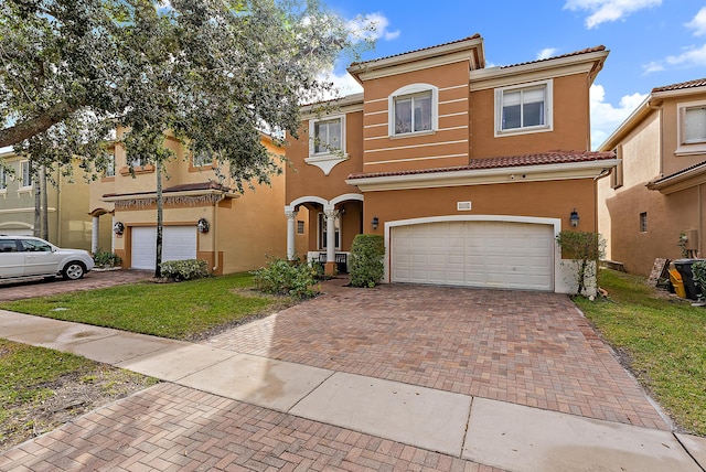 mediterranean / spanish-style house with a garage and a front yard