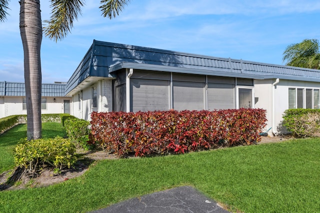 view of property exterior with a lawn