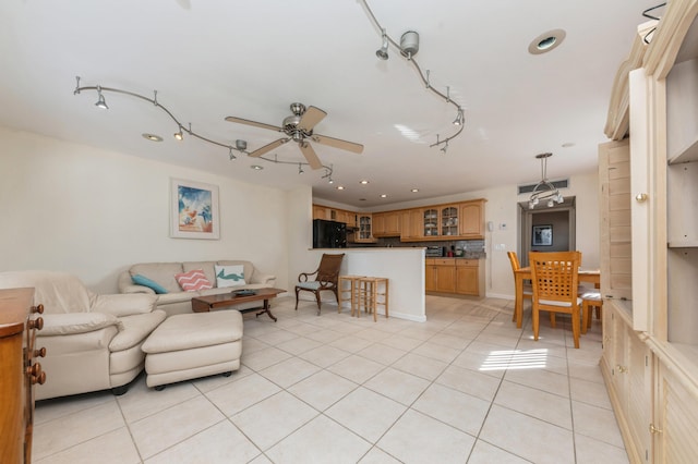 living room with light tile patterned floors, track lighting, and ceiling fan