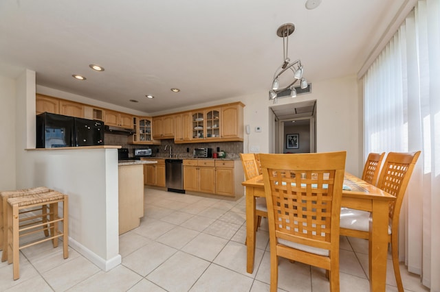 kitchen with sink, black fridge, tasteful backsplash, stainless steel dishwasher, and kitchen peninsula