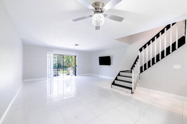 stairs with tile patterned flooring and ceiling fan