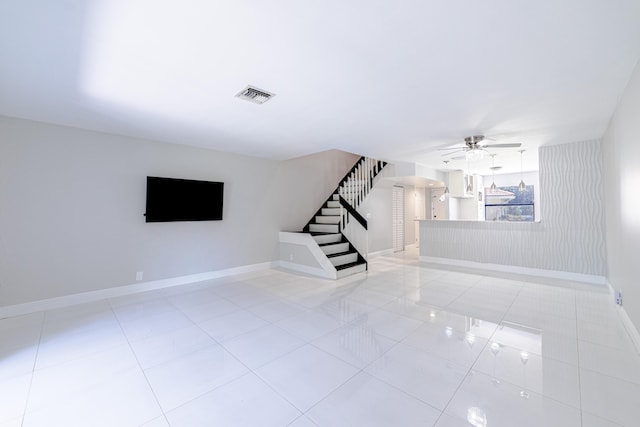 unfurnished living room with ceiling fan and light tile patterned floors