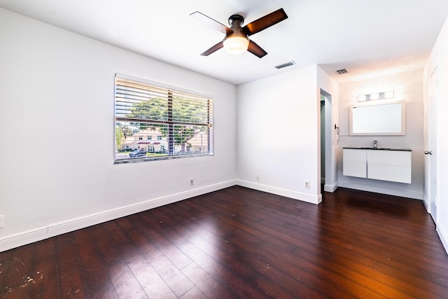 unfurnished bedroom featuring dark hardwood / wood-style floors and ceiling fan