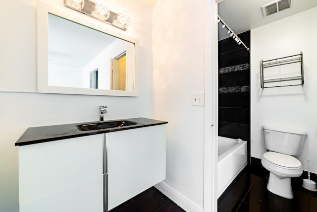 full bathroom with vanity, toilet, and tiled shower / bath