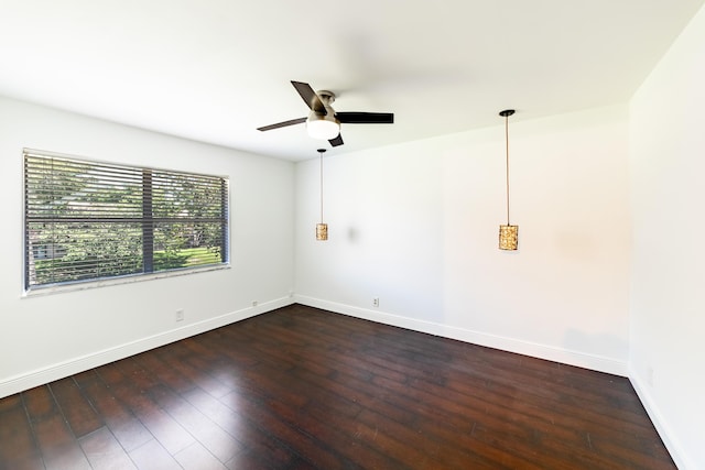 unfurnished room featuring ceiling fan and dark wood-type flooring